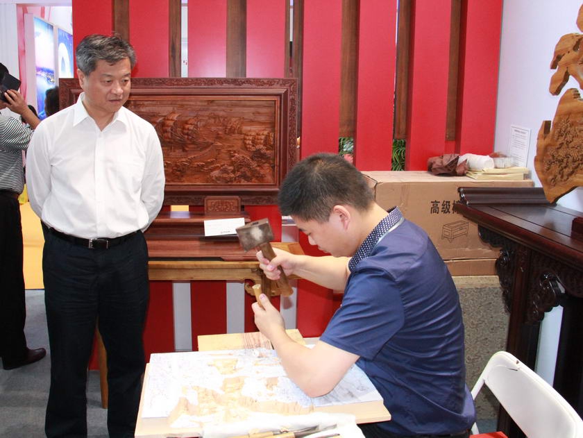 5月15日至19日，第10届文博会在深圳会展中心隆重举行。图为中国出版集团公司总裁谭跃参观木雕艺术展区。