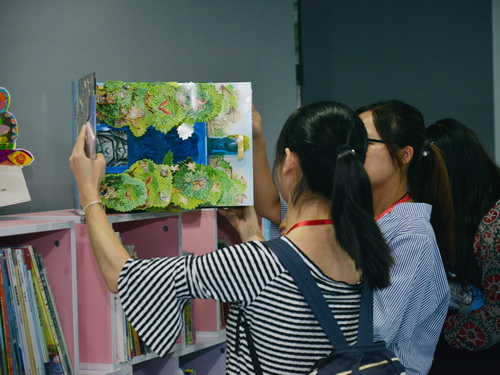 少儿阅读嘉年华现场，参会嘉宾细读展出精品绘本2